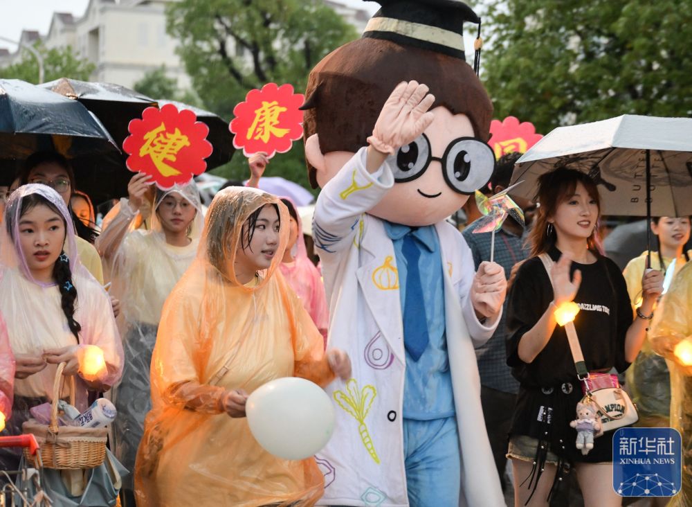 6月21日，海燕策略研究线路一学生在校园里冒雨巡游。2